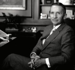 Ross Perot sitting at a desk