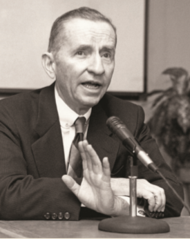 Ross Perot speaking through a microphone