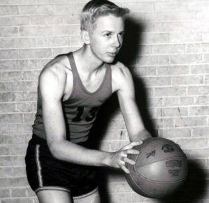 Young T. Boone Pickens wearing a basketball uniform and holding a basketball