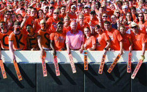 T. Boone Pickens at a Oklahoma State University sports game surrounded by students wearing orange