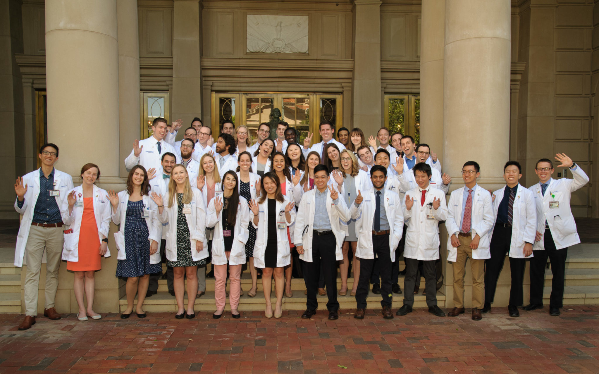 Medical students waving outside of the Southwestern Medical Foundation office