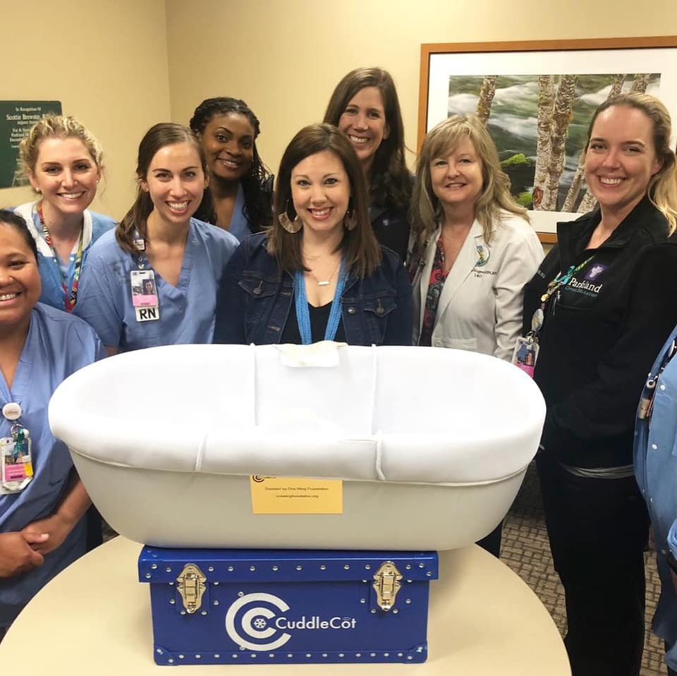Katie Schlieve presents a CuddleCot from One Wing Foundation to Parkland Hospital.