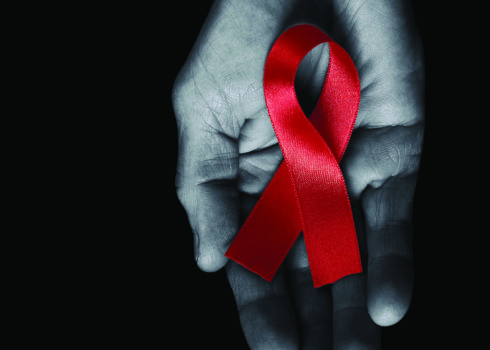 Aids awareness ribbon in a hand