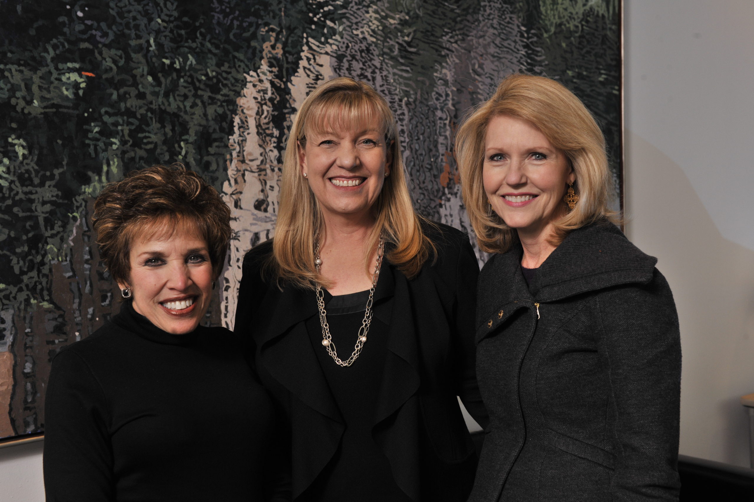 Two women involved with WISMAC pose for a photo with Kathleen Gibson, president of Southwestern Medical Foundation.