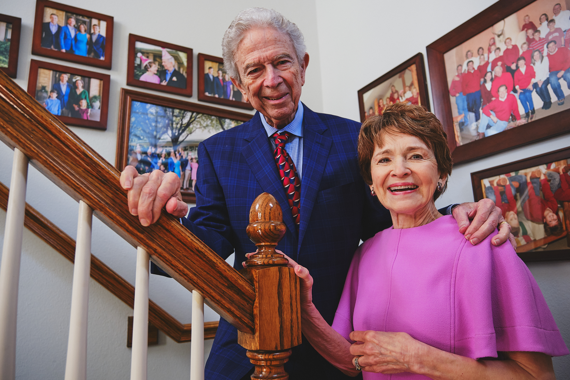 Mary Stewart and Jim Ramsey photographed surrounded by family photos. Their family and community inspired them to support the elderly populations through a donation towards palliative care.