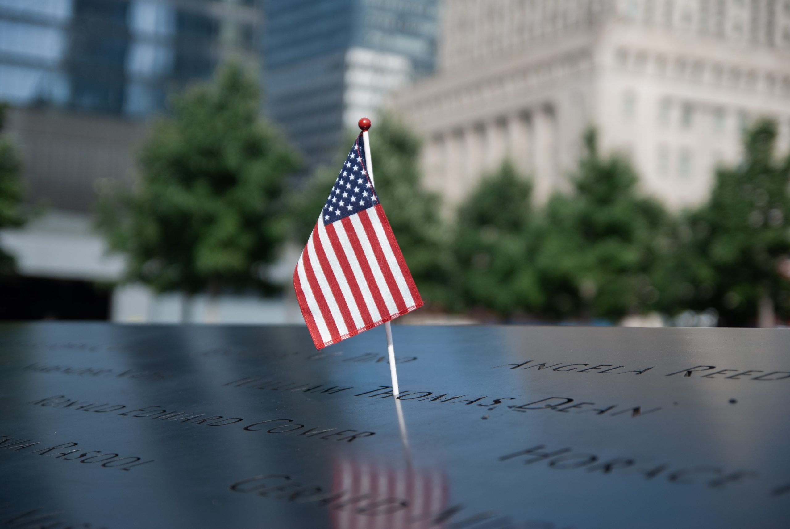 A United States flag place at the world trade center memorial in New York honoring both the victims and the heroes of 9/11.