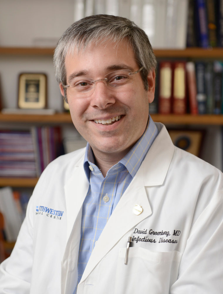 Dr. David Greenberg smiling in a white coat