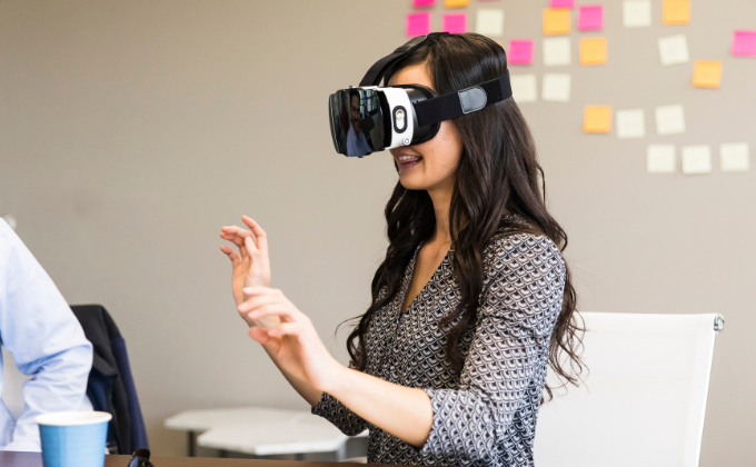 A female student demonstrating the future of medical education with a virtual reality headset.