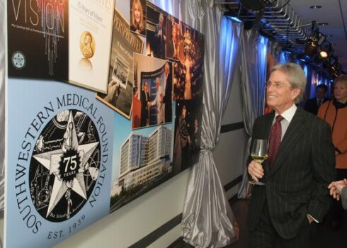 John McStay looking at the historical display at Southwestern Medical Foundation's 75th anniversary.