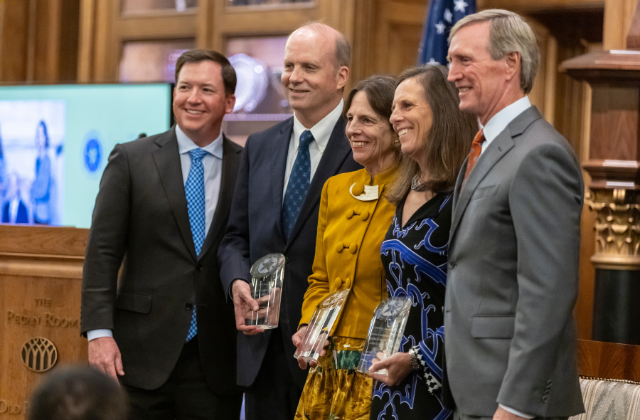 The honorees of the 2023 Sprague Award Jim Bass, Bonnie Bass Smith, and Barbara Moroney pose for a photo with their award.