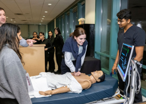 woman practicing cpr at the cary council 2025 kickoff event