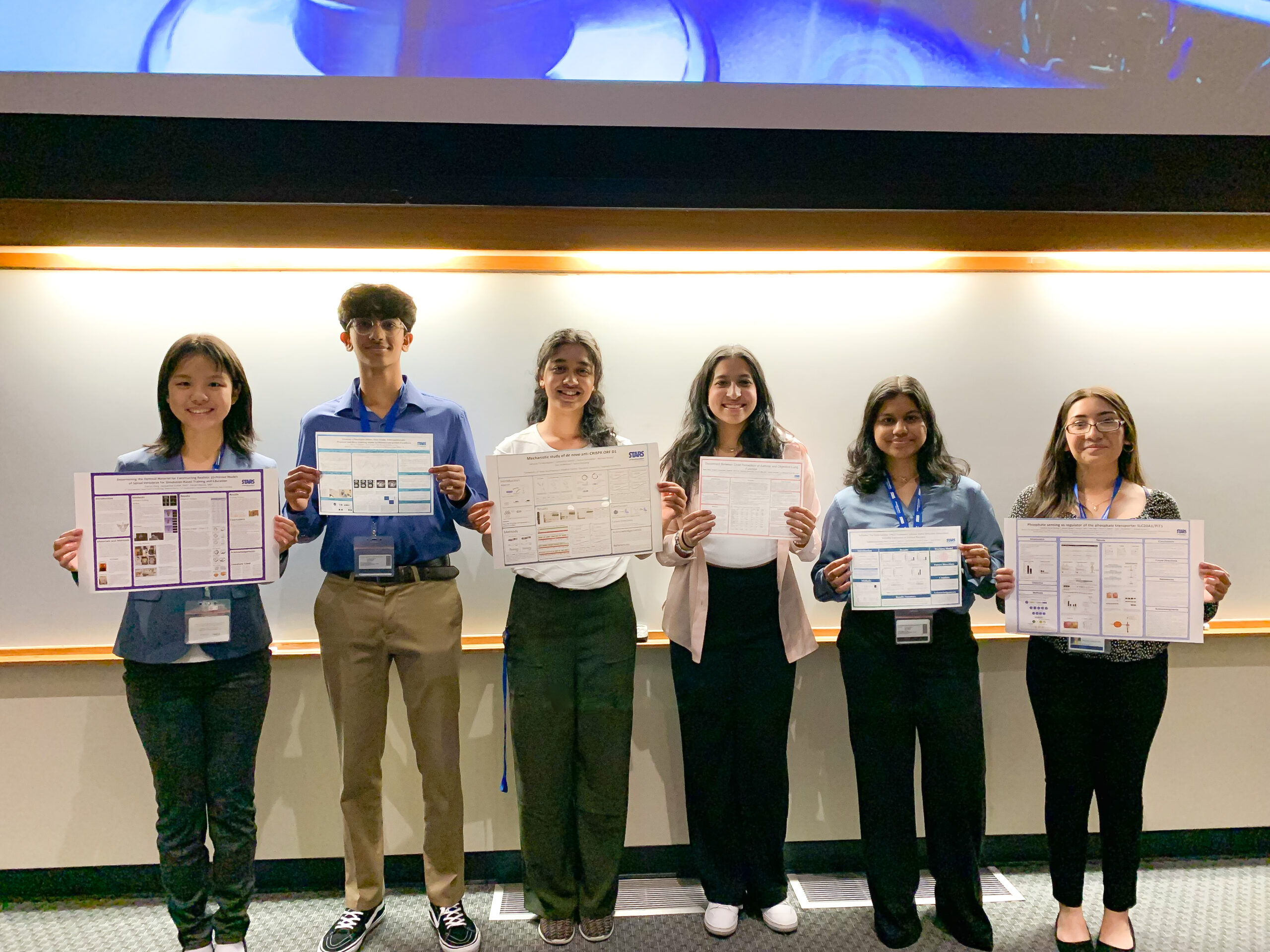 Priddy award recipients holding up their research posters.