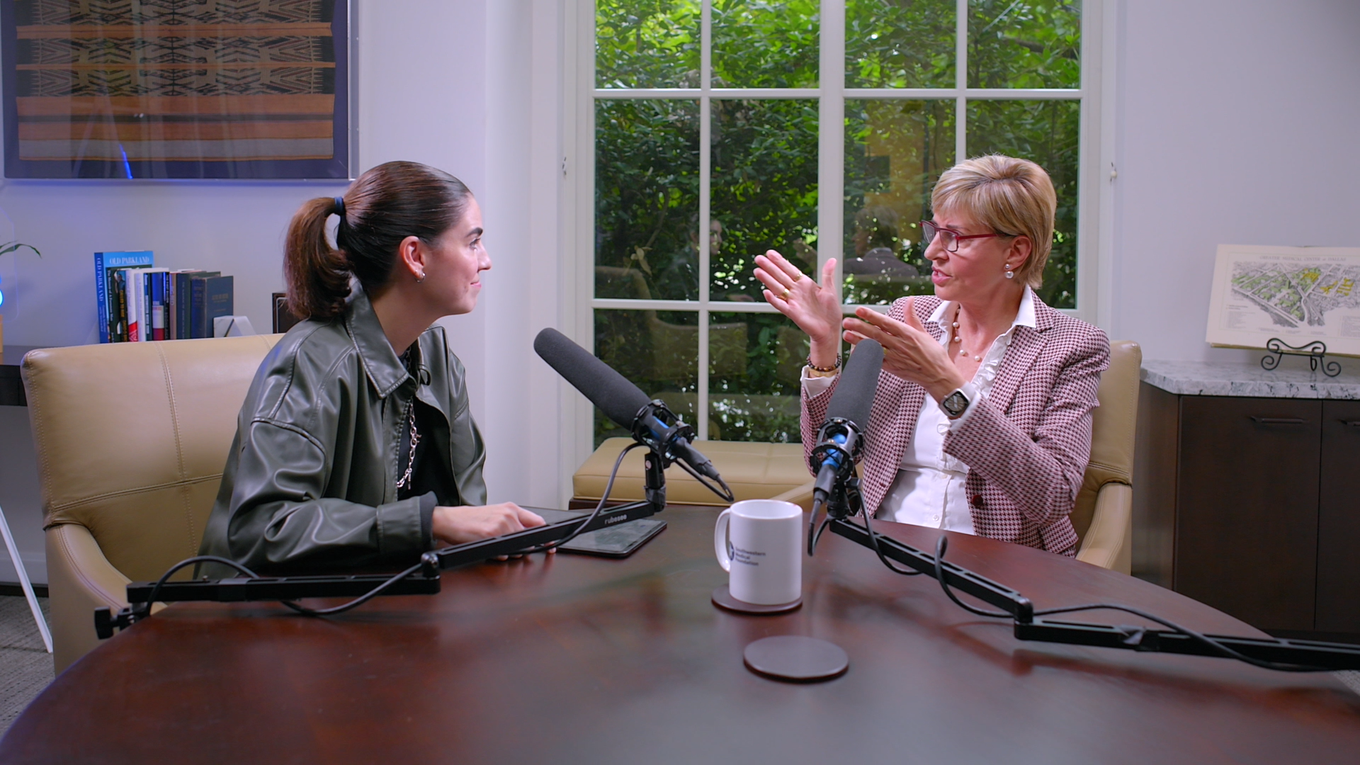 Carine Feyten of Texas Women's University sitting at a table recording a podcast at southwestern medical foundation's offices.